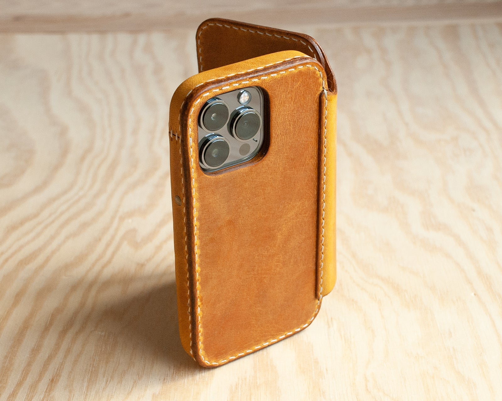 Honey leather iPhone wallet folio open, showing card slots, TRIM