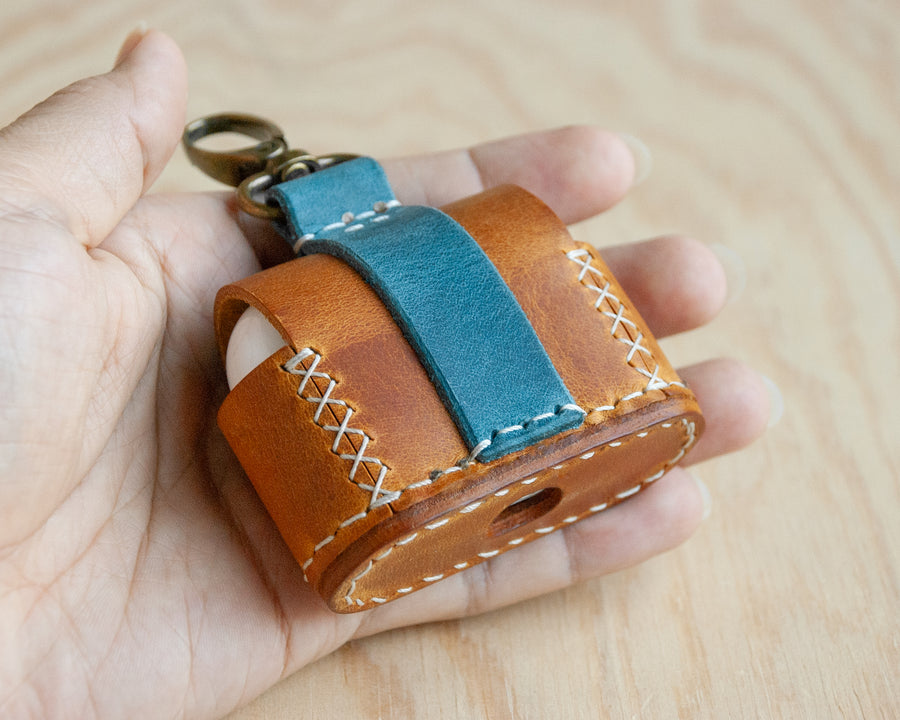 Leather AirPods case on surface, TRIM studio
