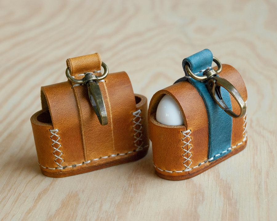 TRIM leather AirPods case flat lay, studio shot