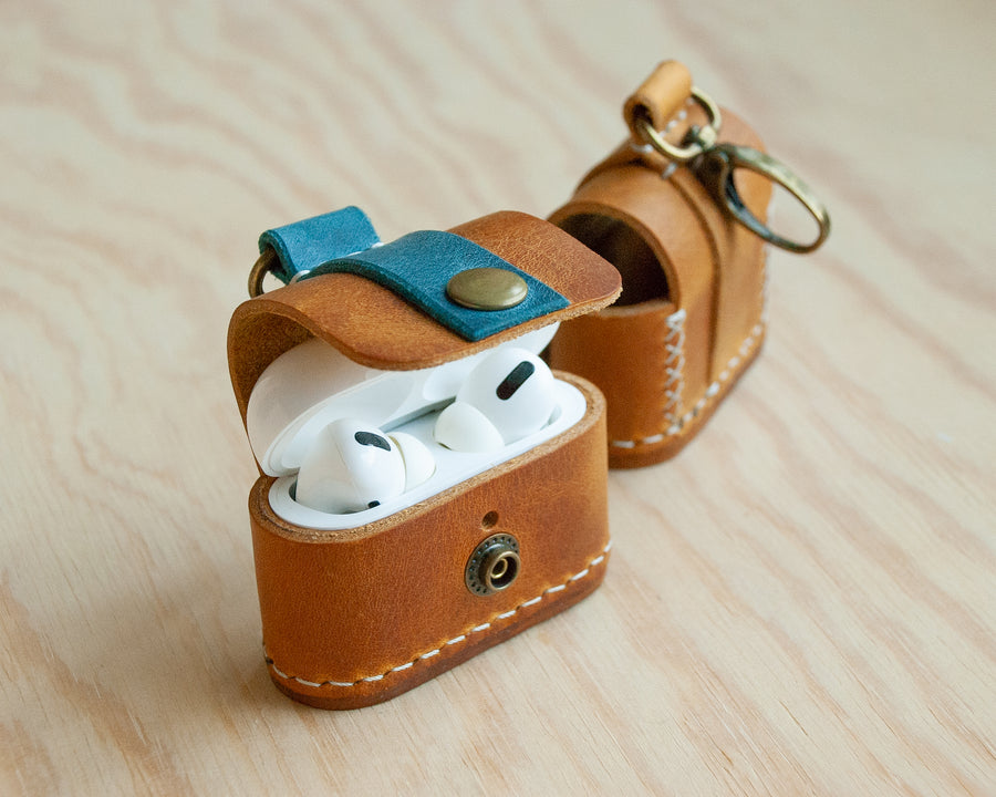 Handmade leather AirPods case showing snap closure