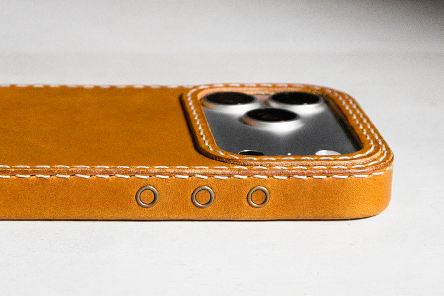TRIM Honey leather iPhone case showing action button side