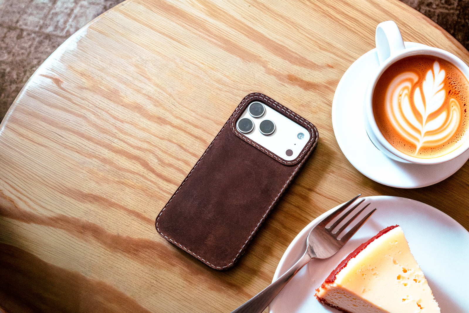 TRIM Walnut leather iPhone case lifestyle, dark brown patina